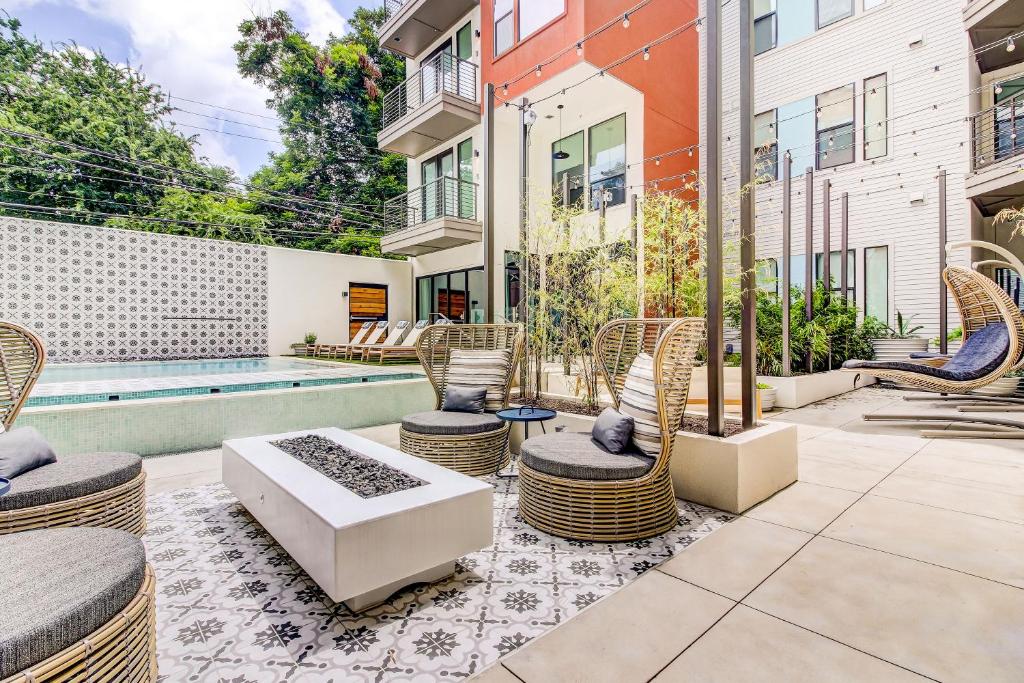 an outdoor patio with chairs and a pool at Sentral East Austin at 1614 E Sixth in Austin