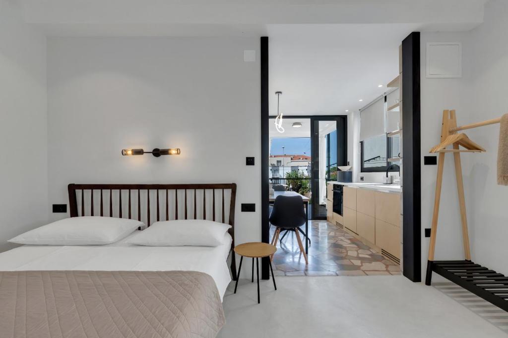 a bedroom with a large bed and a kitchen at Casa Galleria Rica in Makarska