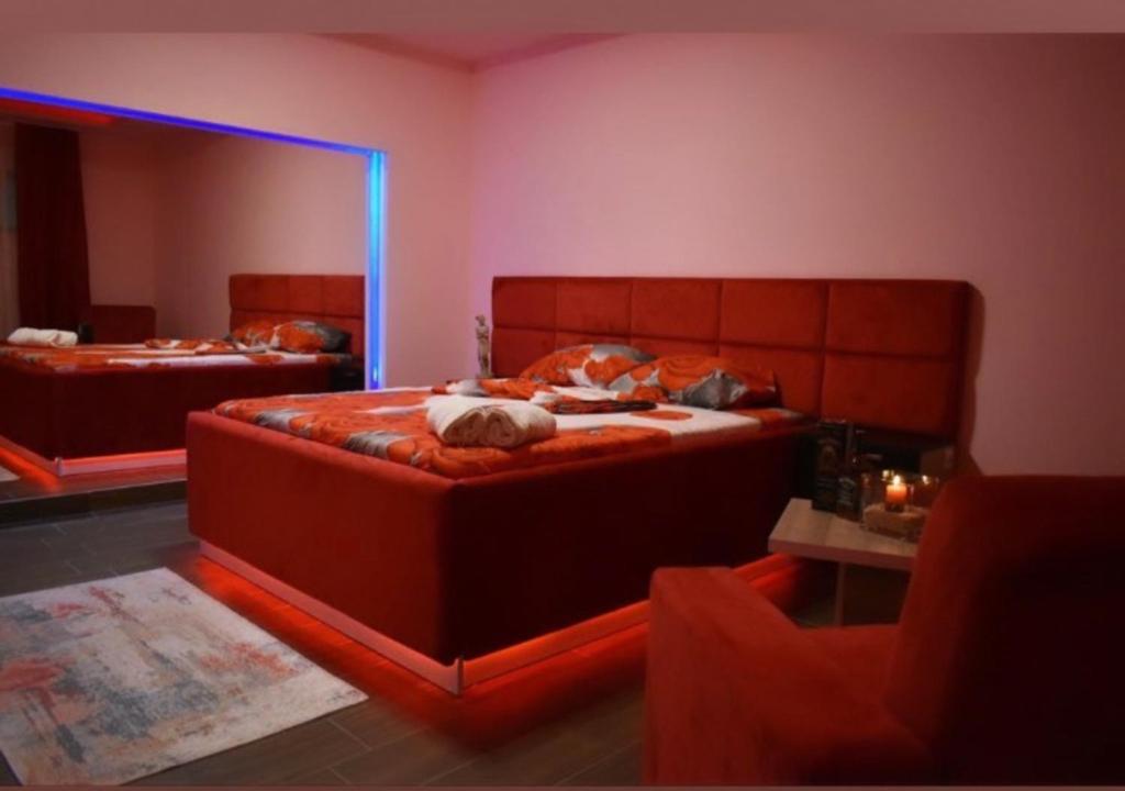 a bedroom with two beds and a large mirror at Motel Villa STAR in Gnjilane