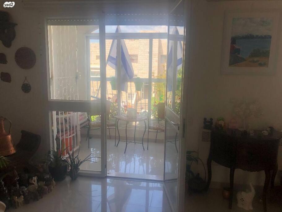 a living room with a door open to a patio at Best Home Jerusalem Holy Land Close to Everything Israel Gateway 4 families & individual in Jerusalem