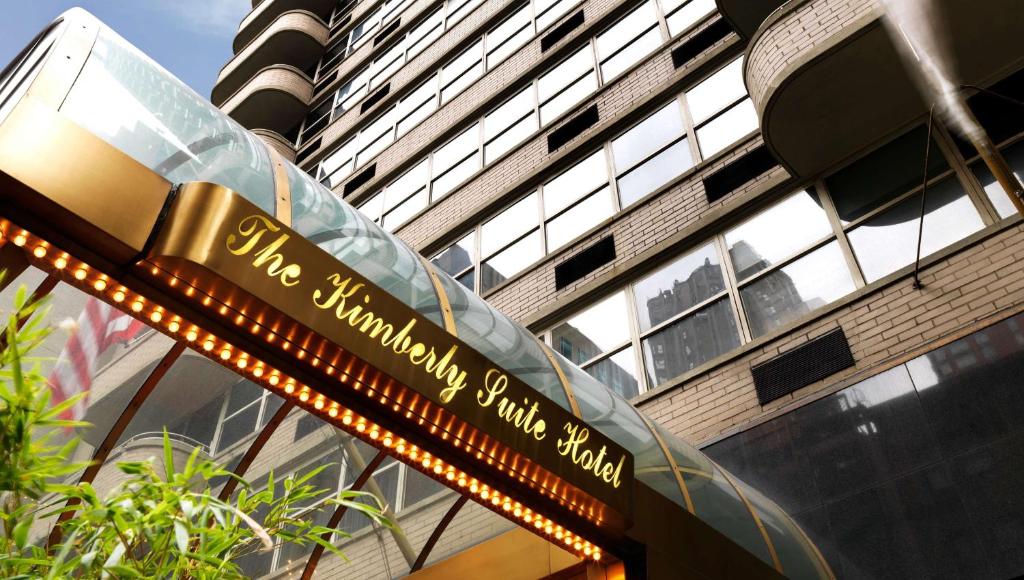 a street sign in front of a tall building at The Kimberly Hotel in New York