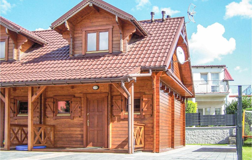 a wooden house with a large door in front at Nice Home In Sianozety With Kitchenette in Sianozety