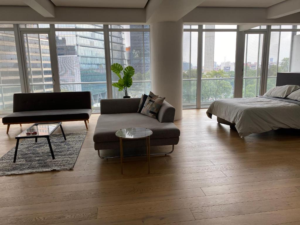 1 dormitorio con cama, sofá y mesa en Loft, en Ciudad de México