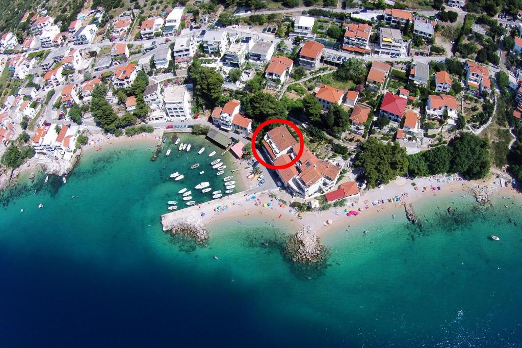 an aerial view of a resort on a beach at Apartments by the sea Pisak, Omis - 1070 in Mimice