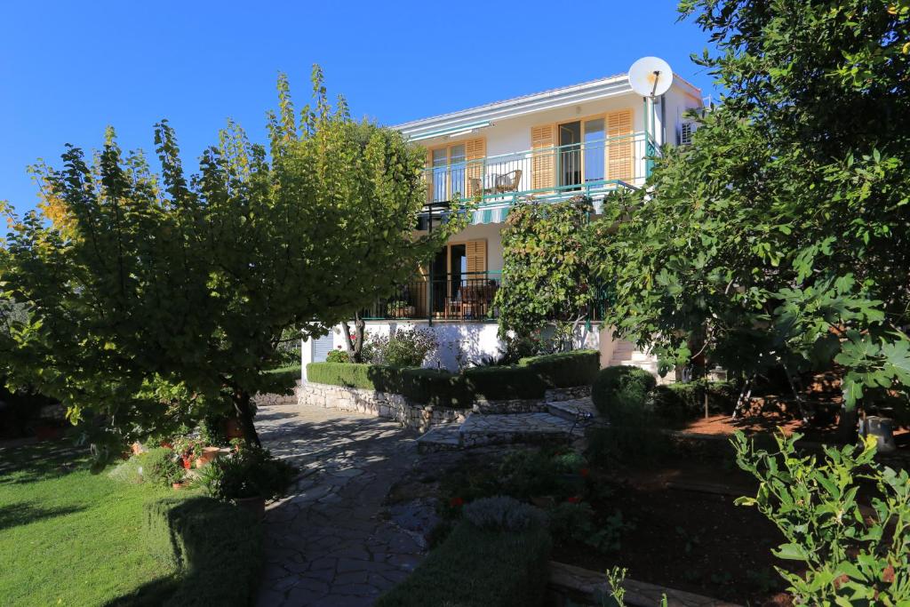 a house with a garden in front of it at Apartments by the sea Sevid, Trogir - 2044 in Sevid
