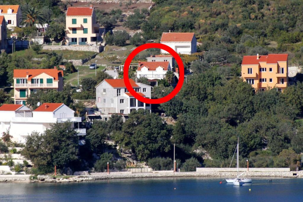 a red circle on top of a house near the water at Apartments and rooms with parking space Slano, Dubrovnik - 2159 in Slano