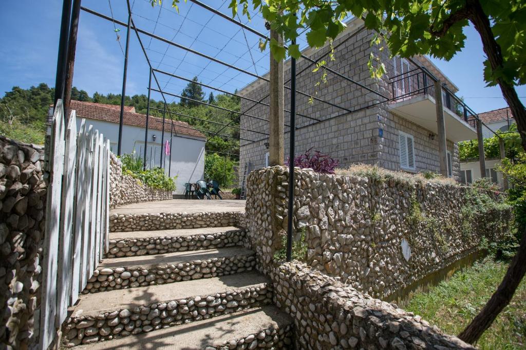 a set of stone stairs next to a stone wall at Rooms with WiFi Lopud, Elafiti - 2169 in Lopud