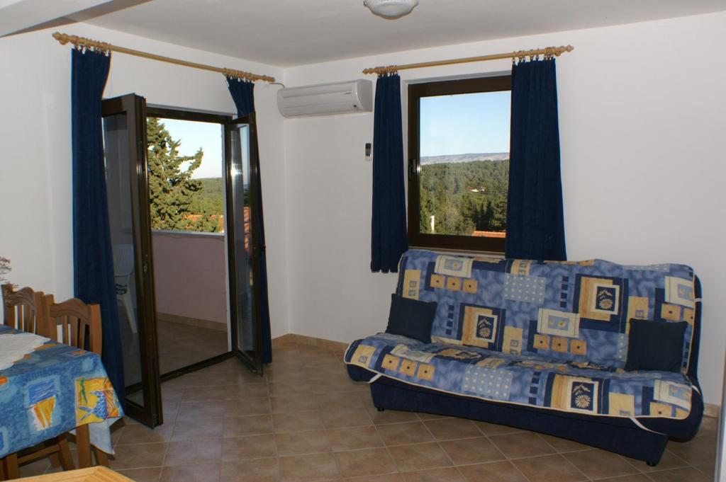 a living room with a couch and a window at Apartments with a parking space Stari Grad, Hvar - 4014 in Stari Grad