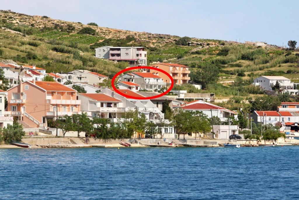 a house in a town next to the water at Apartments with a parking space Metajna, Pag - 4127 in Zubovići