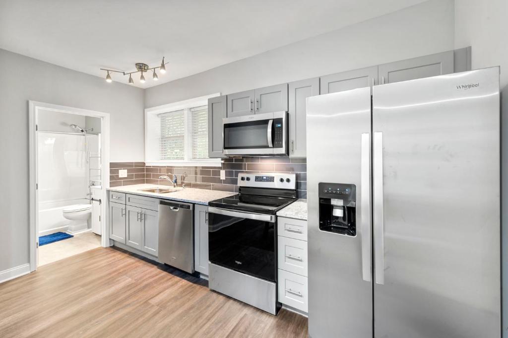 a kitchen with stainless steel appliances and a refrigerator at The Secluded Secret in Stone Mountain in Stone Mountain