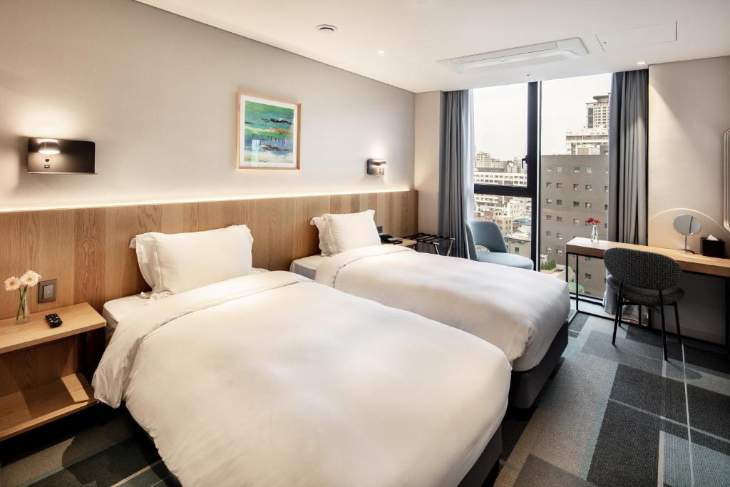 Cama ou camas em um quarto em G3 Hotel Chungmuro