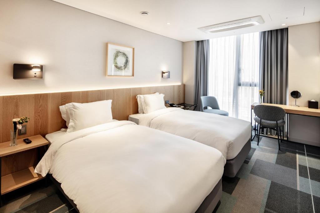 Cama ou camas em um quarto em G3 Hotel Chungmuro