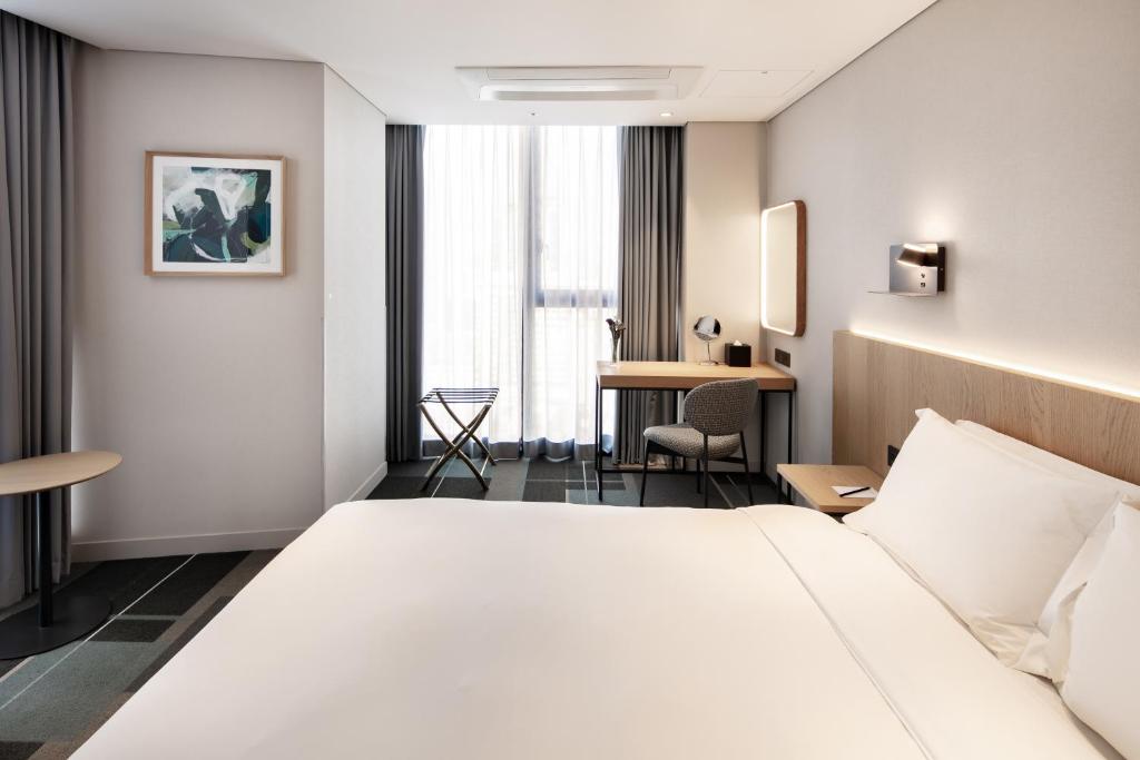 Cama ou camas em um quarto em G3 Hotel Chungmuro