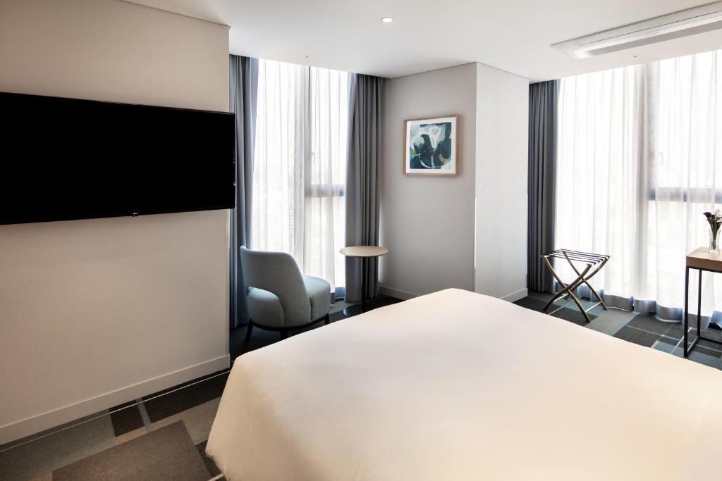 Uma TV ou centro de entretenimento em G3 Hotel Chungmuro