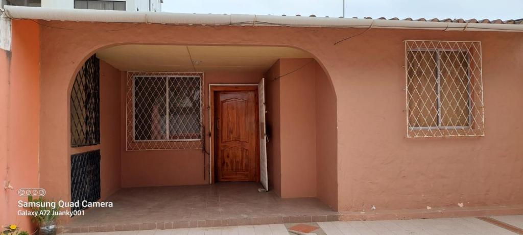 an entrance to a house with a brown door at Puerto Lucía - Salinas Beach in Salinas