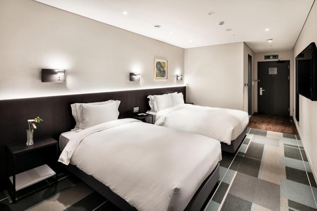 Cama ou camas em um quarto em G3 Hotel Chungmuro