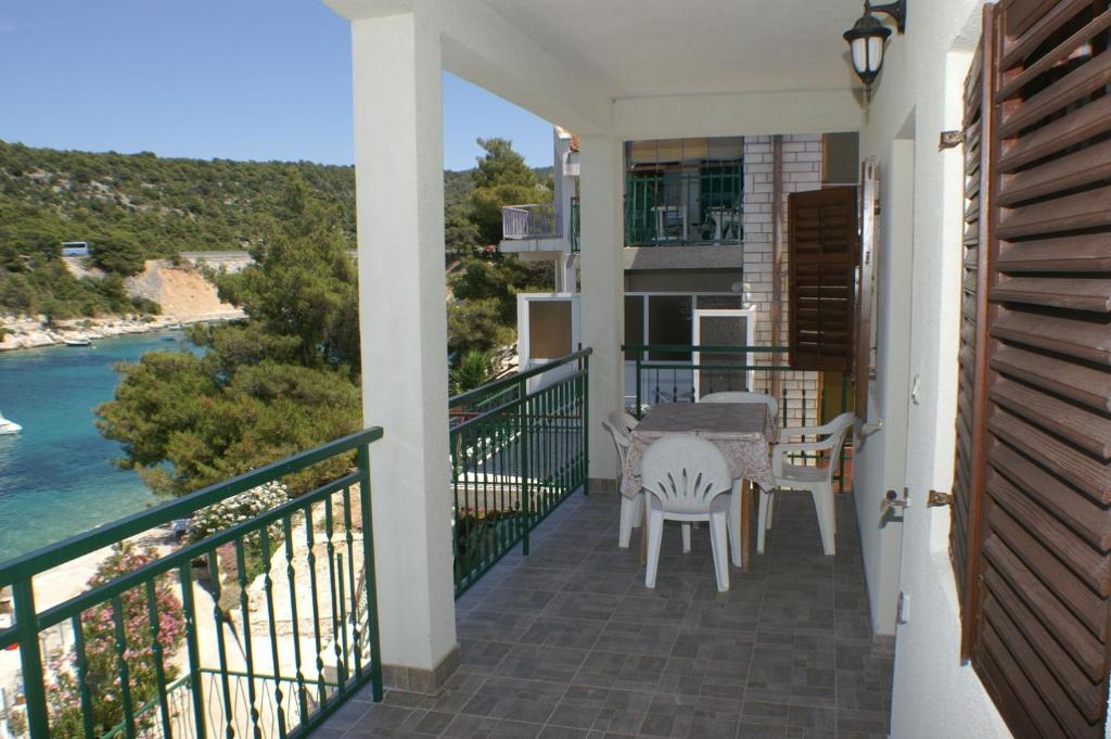a balcony of a house with a table and chairs at Apartment Bilo 4189c in Podgreben