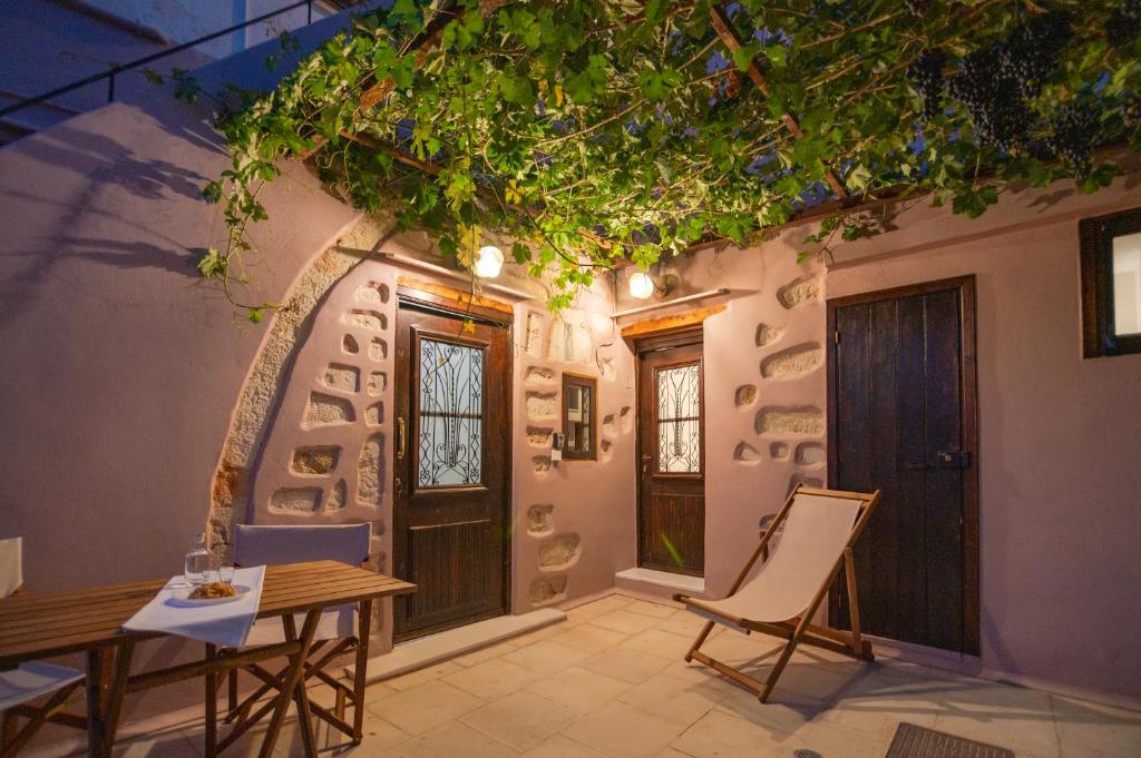a patio with a table and chairs in front of a building at Marthas DeLight Rooms in Chania
