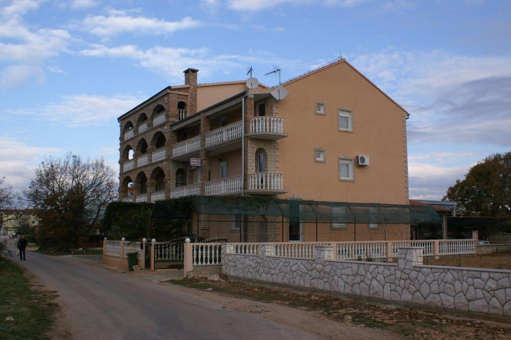 a large building on the side of a road at Apartments and rooms with parking space Biograd na Moru, Biograd - 4305 in Biograd na Moru