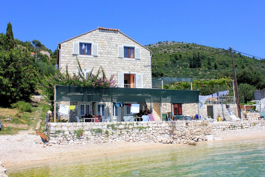 a house on the shore of a beach at Rooms by the sea Sladjenovici, Dubrovnik - 2161 in Slano