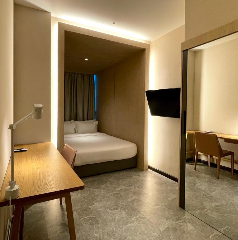 Postel nebo postele na pokoji v ubytování Harper Boutique Hotel at Sutera Avenue