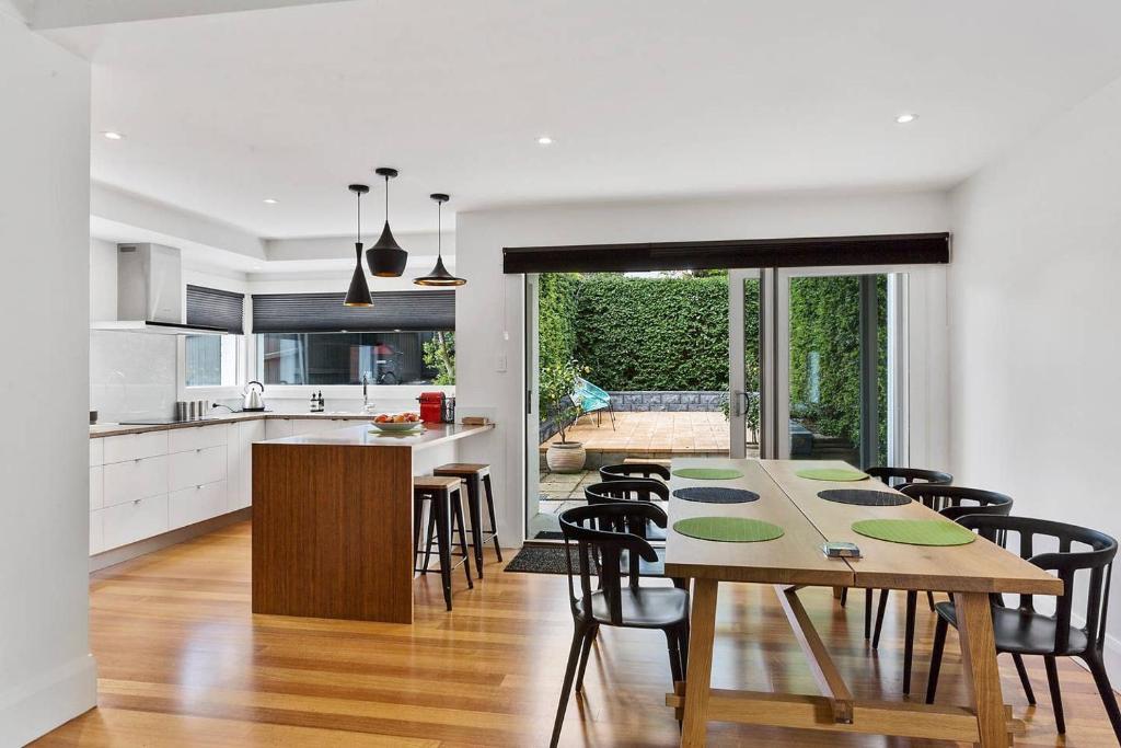 a kitchen and dining room with a table and chairs at Pillinger Street - luxurious renovated home in Hobart