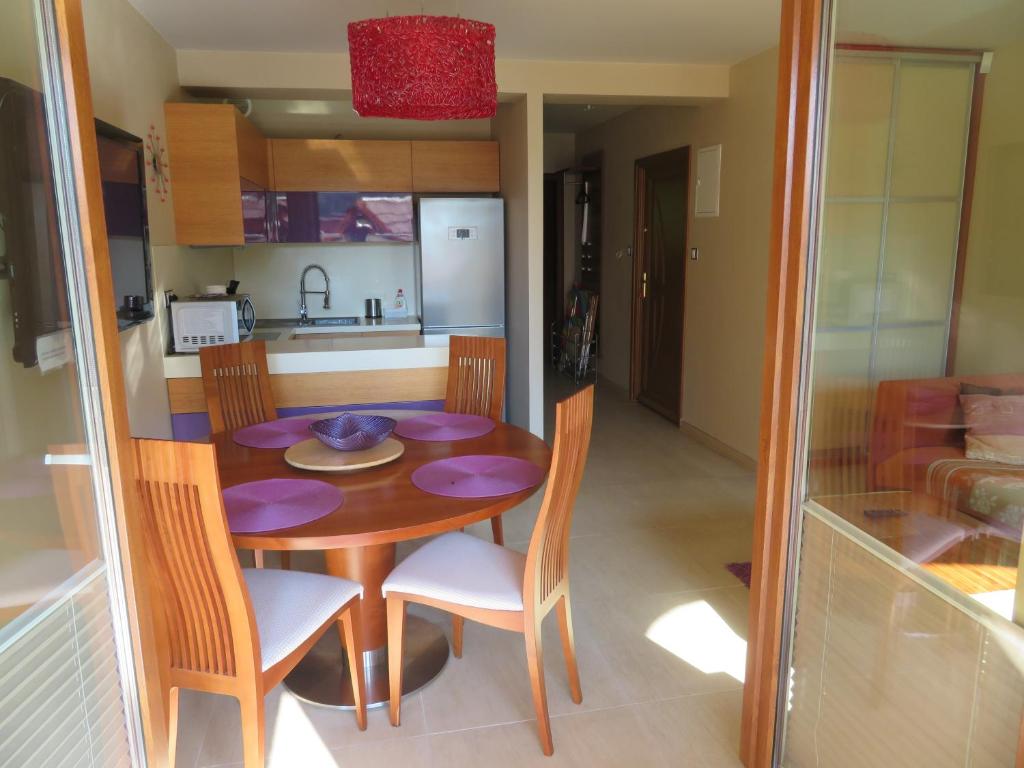 a kitchen and a table and chairs in a room at Apartament Flores 1 in Mielno