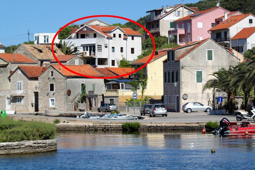 Um círculo vermelho paira sobre um rio em Apartments by the sea Vrboska (Hvar) - 4025 em Vrboska