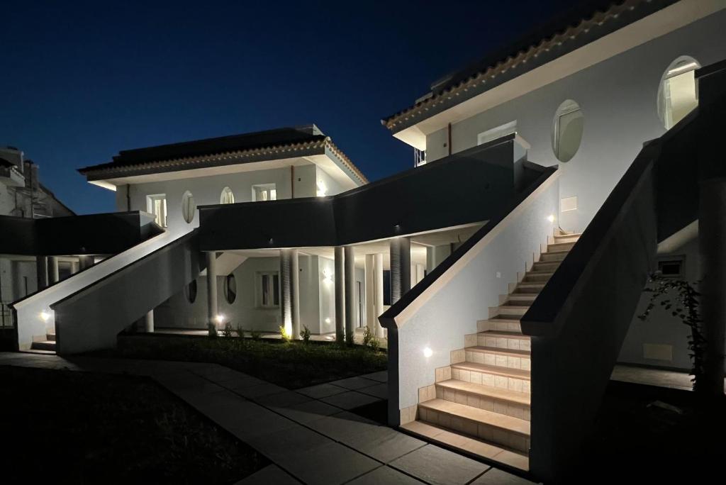 duży biały dom ze schodami w nocy w obiekcie Perla Blu Tropea w Tropei