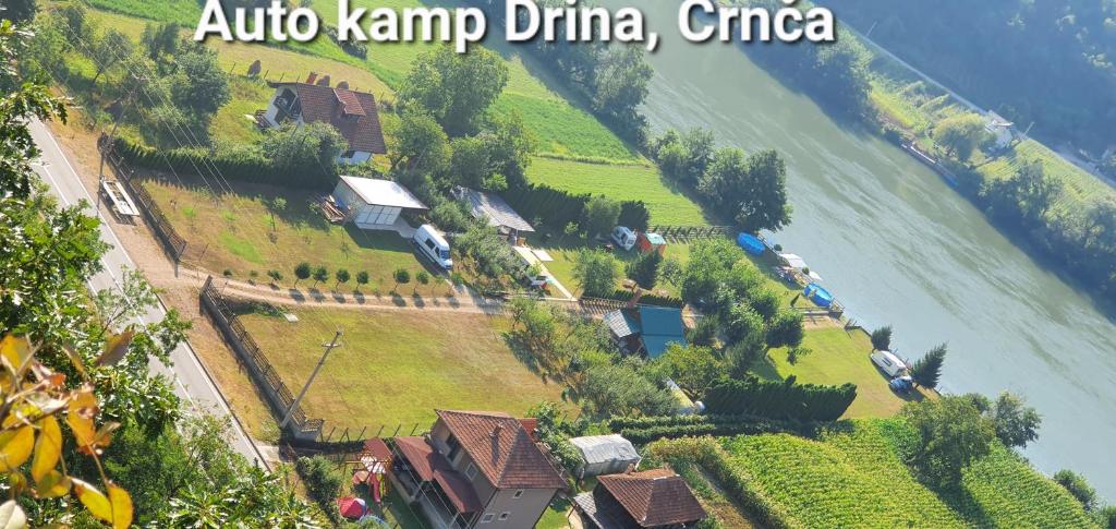 an island with a train on it next to a river at AUTO KAMP DRINA in Crnča