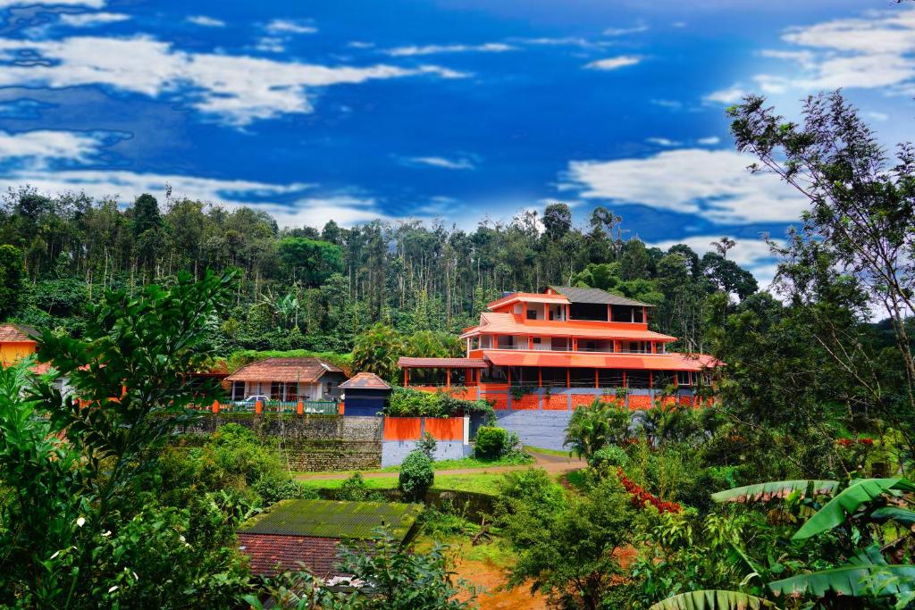 a large house in the middle of a forest at Deva Maani Coorg Nature View in Madikeri