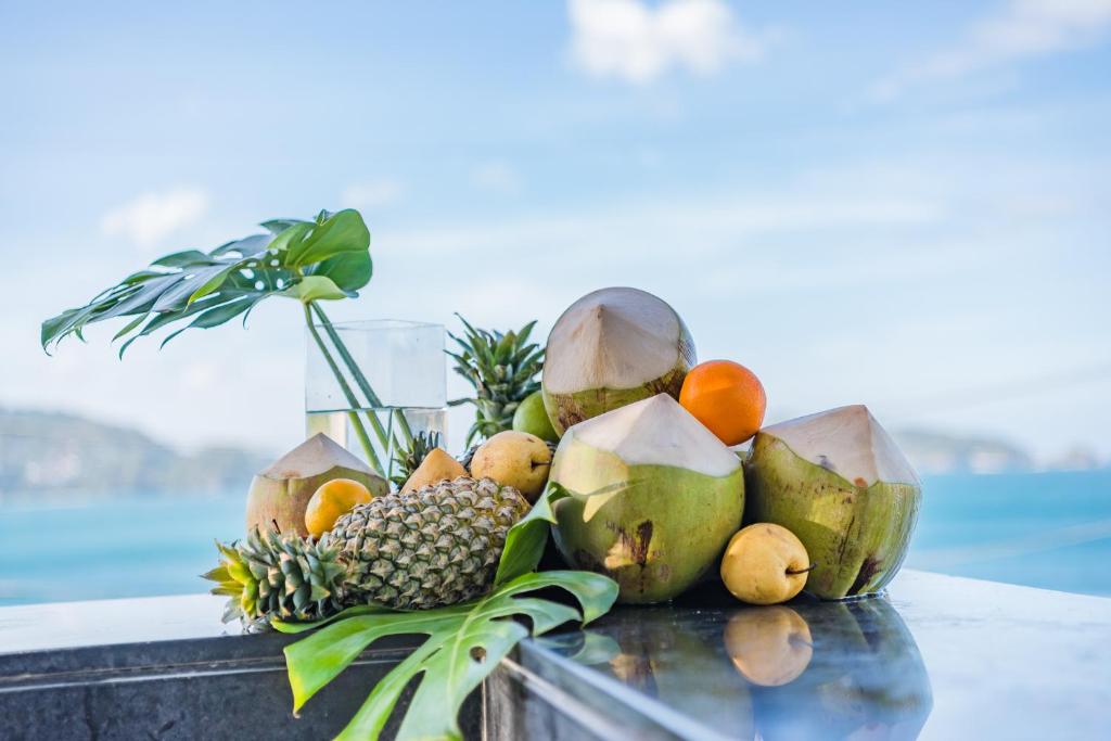 a pile of fruit sitting on a table at Oceanfront Beach Resort - SHA Extra Plus in Patong Beach