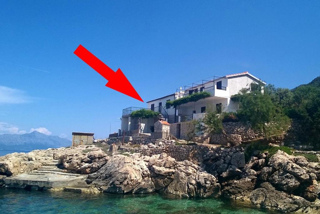 a house on a rocky island in the water at Seaside secluded apartments Cove Virak, Hvar - 4035 in Gdinj