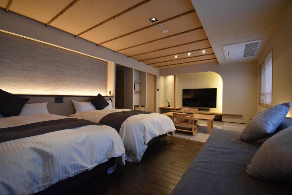 Postel nebo postele na pokoji v ubytování Hotel Kazurabashi