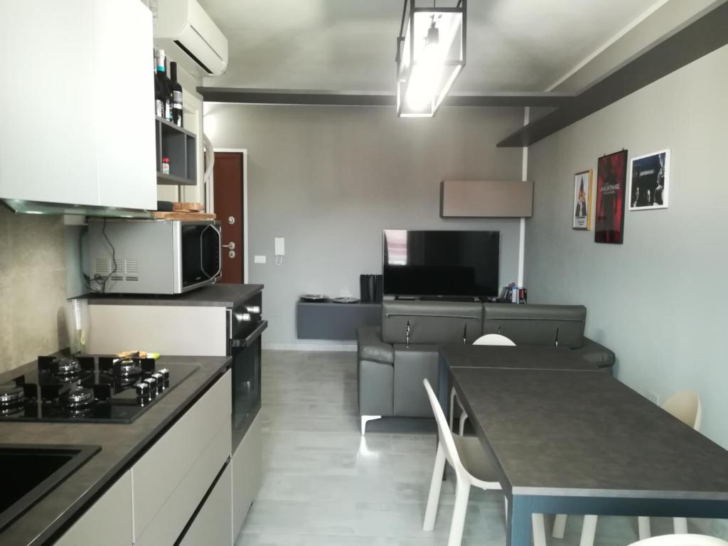 a kitchen with a table and a dining room at Aero Apartment in Elmas