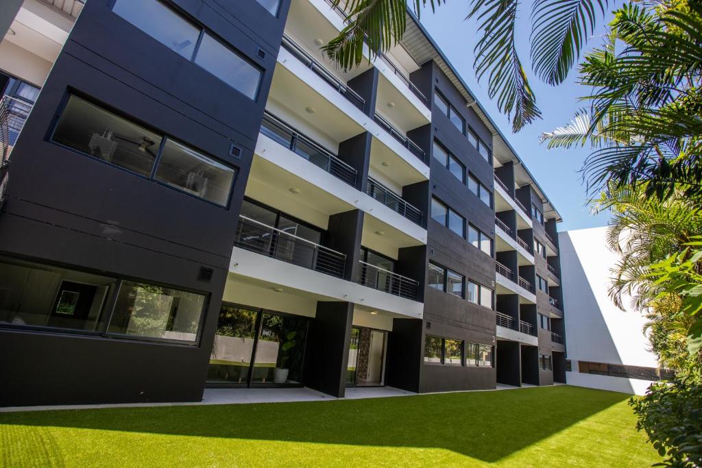 an apartment building with a lawn in front of it at The Space To Be in Durban