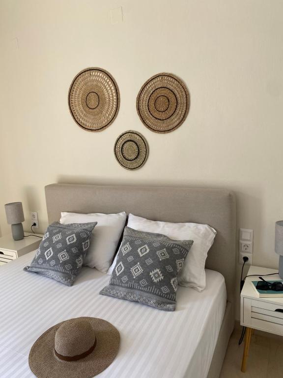 a bedroom with a bed with hats on the wall at Libera Private Rooms in Parga
