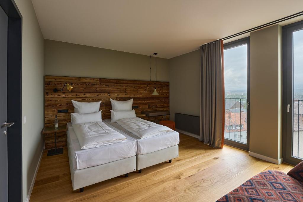 Postel nebo postele na pokoji v ubytování FREIgeist Homes - Serviced Apartments