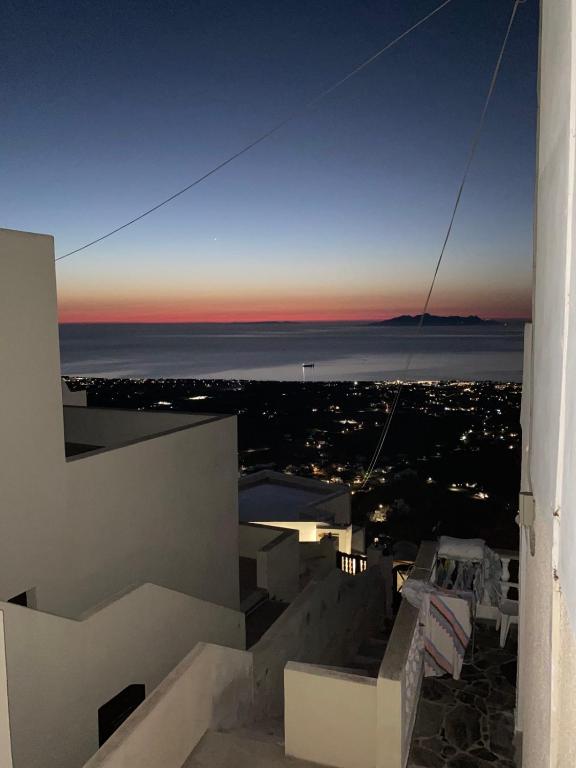 a view of the ocean at sunset from a building at Palaia katoikia Amazing View Pyrgos Santorini in Pyrgos