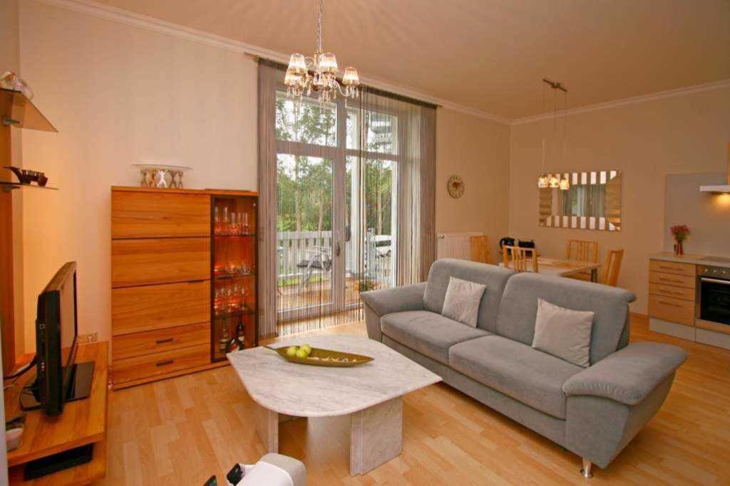 a living room with a couch and a tv at SW6 Haus Wittsand in Spieka-Neufeld