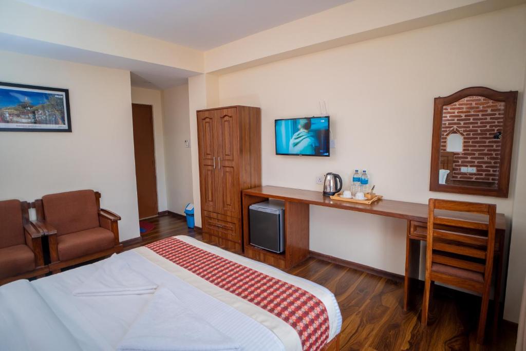 TV a/nebo společenská místnost v ubytování Madhuban Hotel