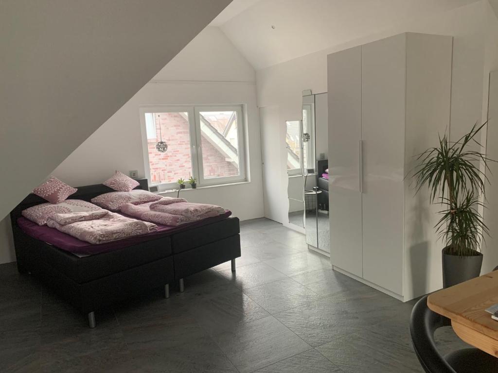 a bedroom with a bed with pink pillows on it at Apartment in toller Lage am Rande des Ruhrgebietes in Bottrop