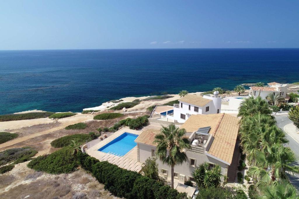an aerial view of a house with a swimming pool at Seafront 5 Bedroom Villa Paradise in Sea Caves in Peyia