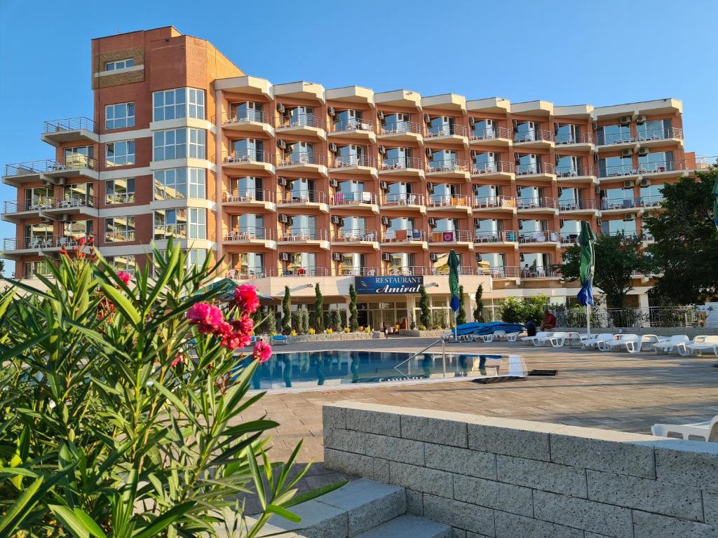 a hotel with a pool in front of a building at Hotel Amiral in Mamaia