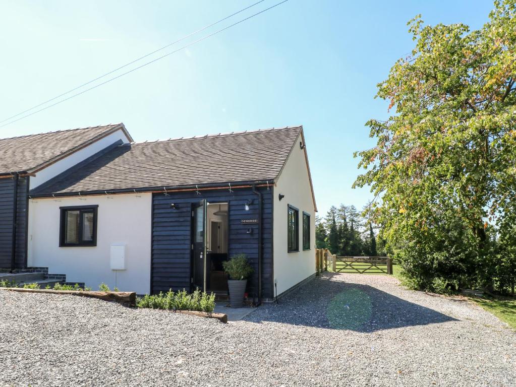 a cottage with a gravel driveway in front of it at The Wood Shed, Bank Top Farm in Ashbourne