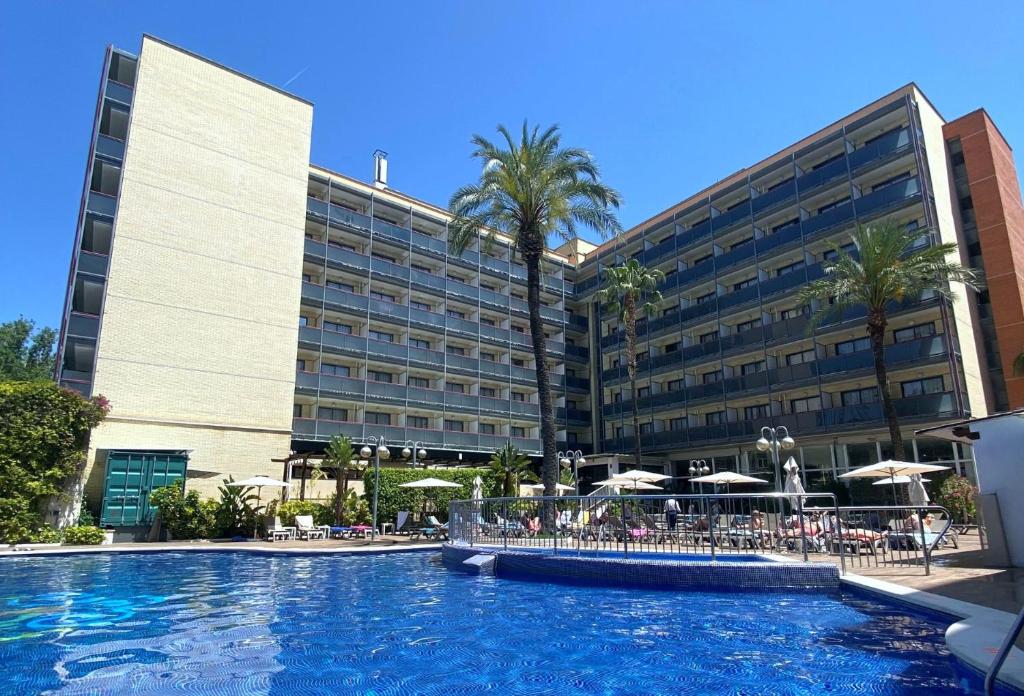 a hotel with a swimming pool in front of a building at Eurosalou & Spa in Salou