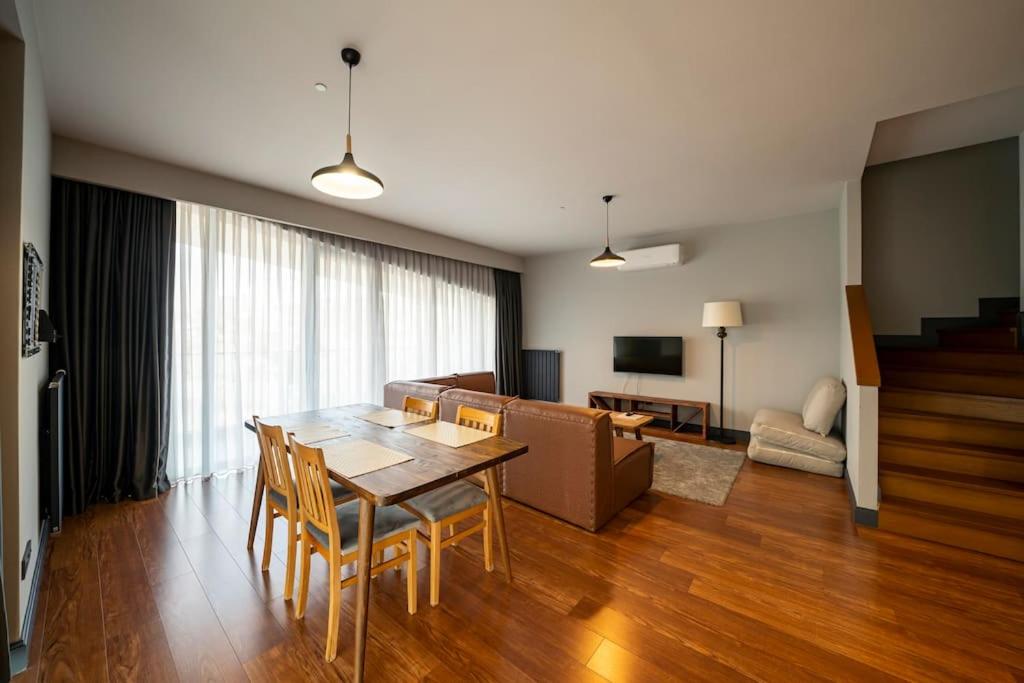 a living room with a table and chairs and a couch at Superior, classy residence,7&#47;24 Security,2 bedroom ( Benesta 205 ) in Istanbul