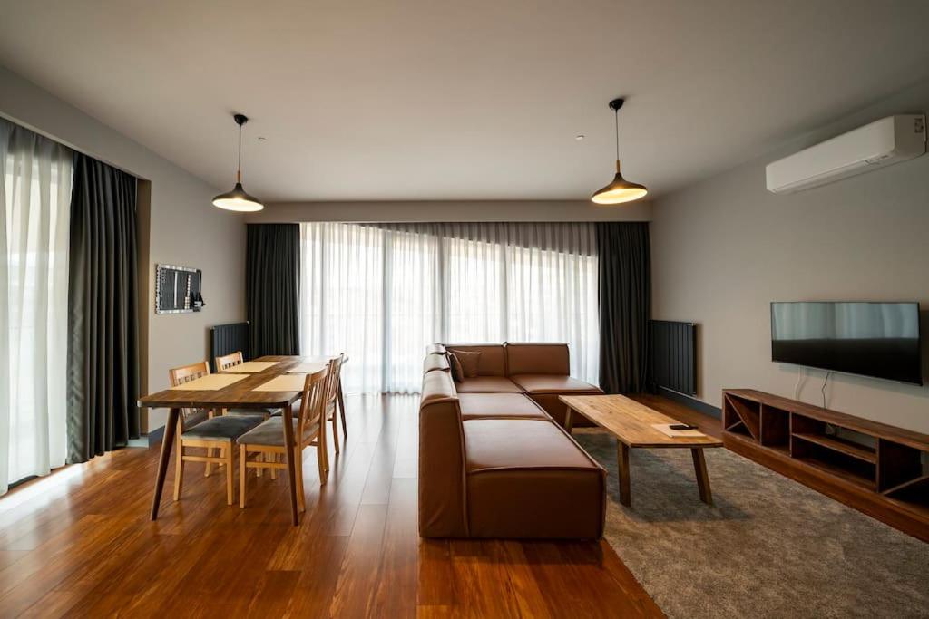 a living room with a couch and a table at Superior, classy residence,7&#47;24 Security,2 bedroom ( Benesta 205 ) in Istanbul