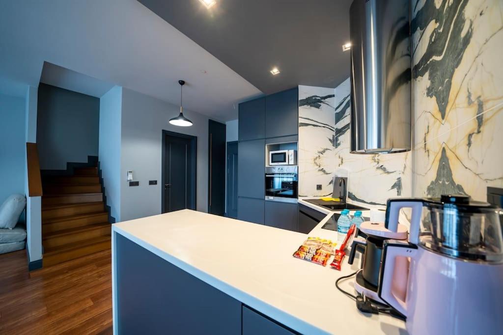 a kitchen with blue cabinets and a white counter top at Superior, classy residence,7&#47;24 Security,2 bedroom ( Benesta 205 ) in Istanbul