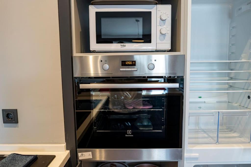 a microwave sitting on top of an oven at Superior, classy residence,7&#47;24 Security,2 bedroom ( Benesta 205 ) in Istanbul